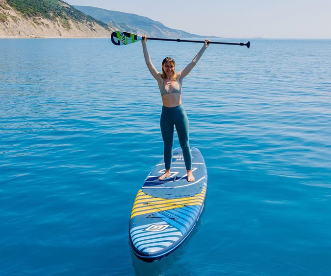 IMR Woman holding paddle while standing on paddleboard